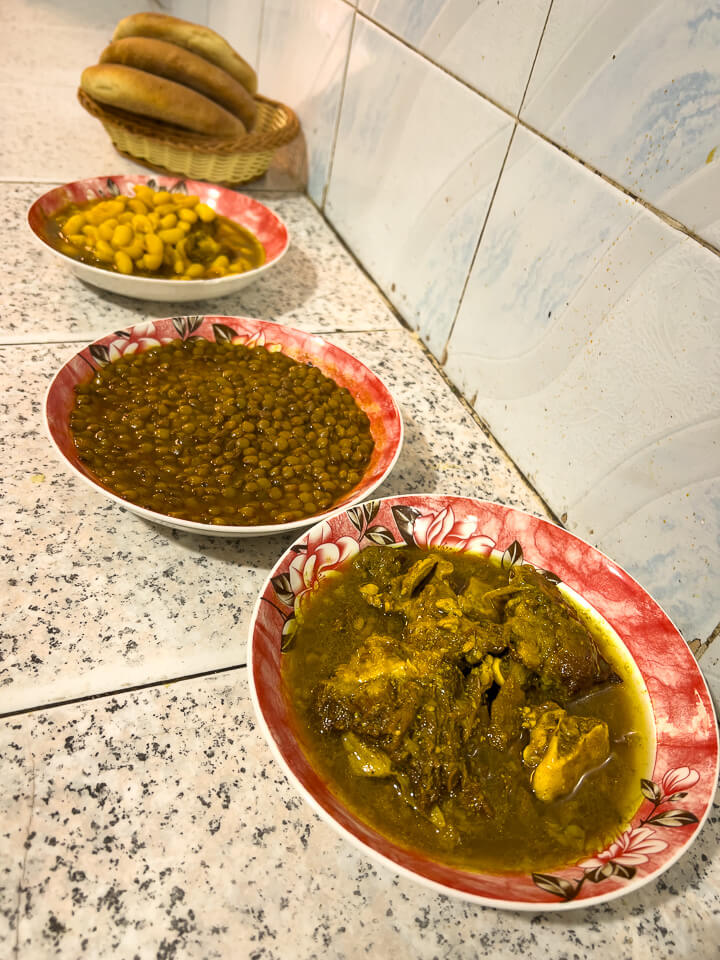 A typical meal for a worker in Morocco: bread, lentils and meat with sauce.