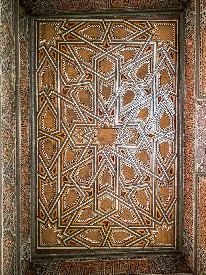 Painted and carved ceiling. Ben Youssef Madrasa Marrakesh.