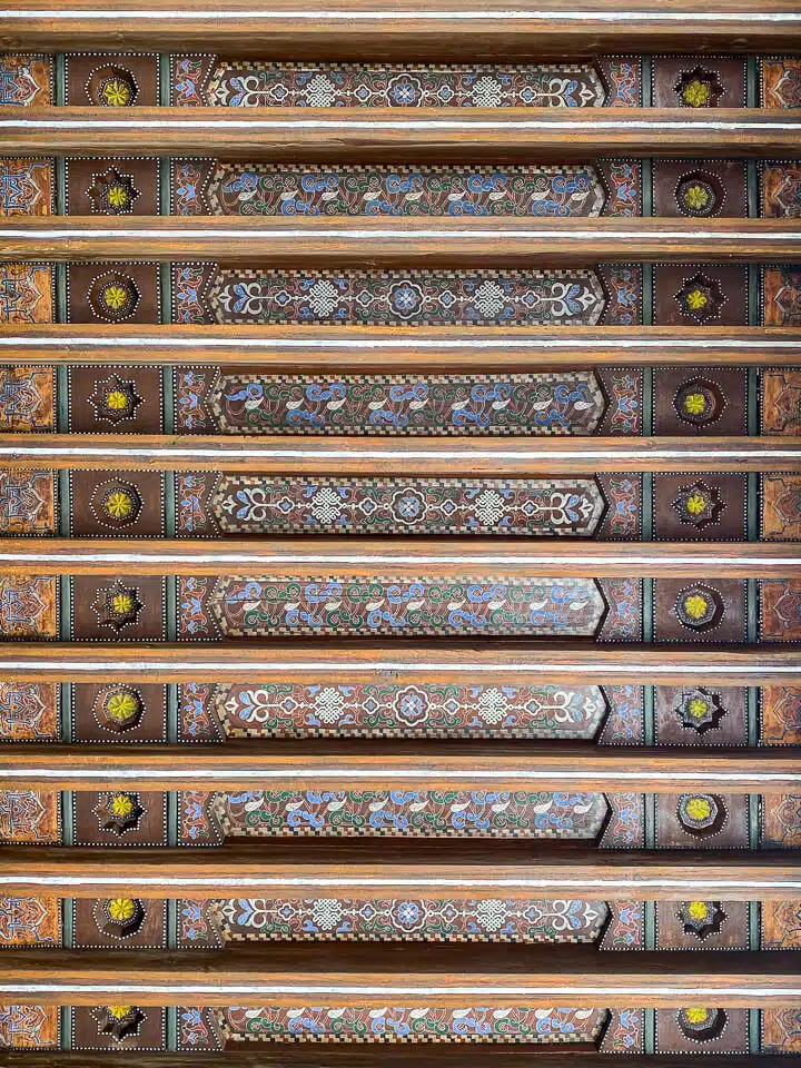 Painted roof beams in the wooden ceiling of the Ben Youssef Madrasa.